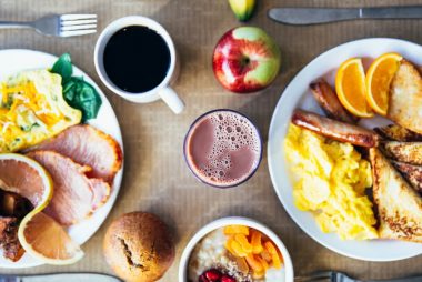 Vibrant breakfast with eggs, fruits, toast, and coffee for a wholesome start.